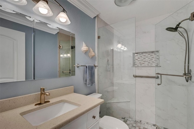 bathroom with toilet, vanity, a shower with shower door, and ornamental molding