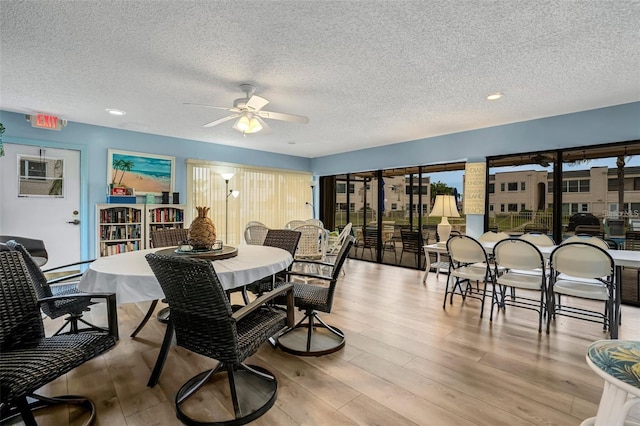 dining area featuring a textured ceiling, light hardwood / wood-style flooring, and ceiling fan