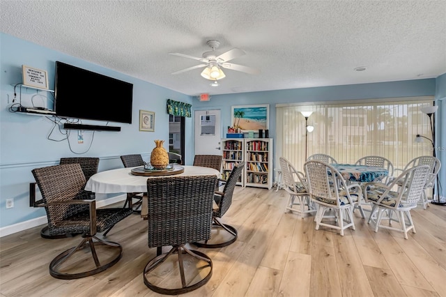 dining area with ceiling fan, a textured ceiling, and light wood-type flooring