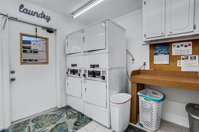 washroom featuring light tile patterned floors and stacked washer / dryer