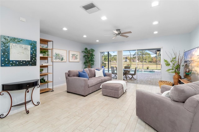 living room featuring ceiling fan and light wood-type flooring