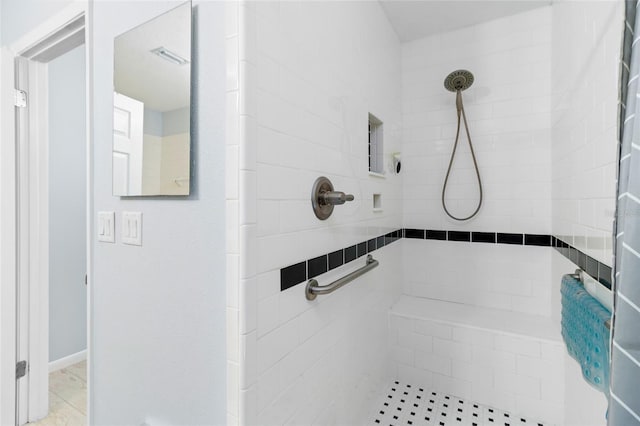 bathroom with tiled shower