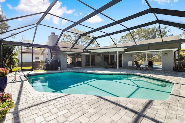 view of swimming pool with a lanai, a patio, and ceiling fan