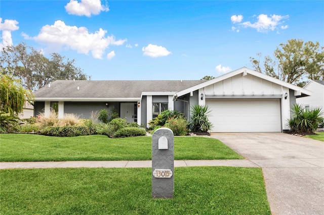 ranch-style house with a garage and a front lawn