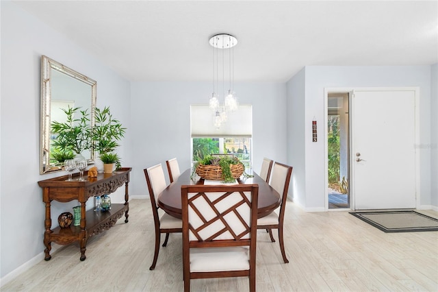 dining room with a chandelier and light wood-type flooring