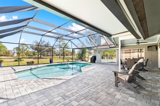 view of pool with ceiling fan, a lanai, and a patio