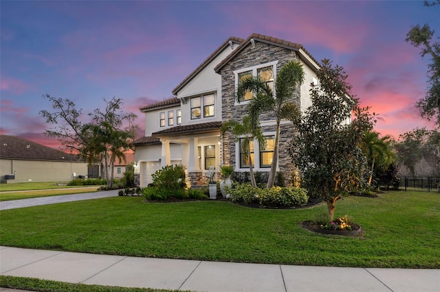 view of front of home featuring a yard and a garage