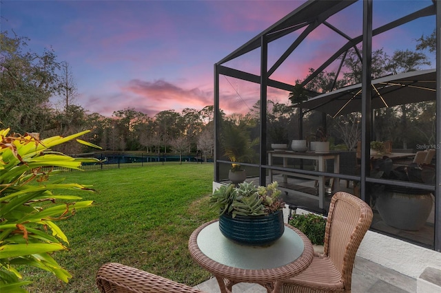 view of yard with glass enclosure, a patio, and fence