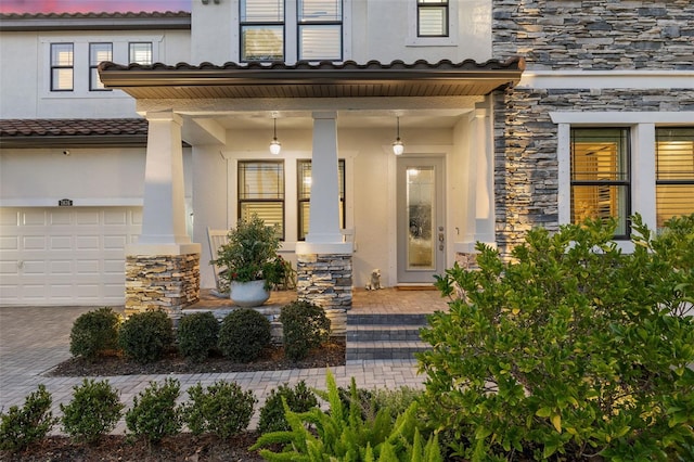 property entrance with a porch and a garage