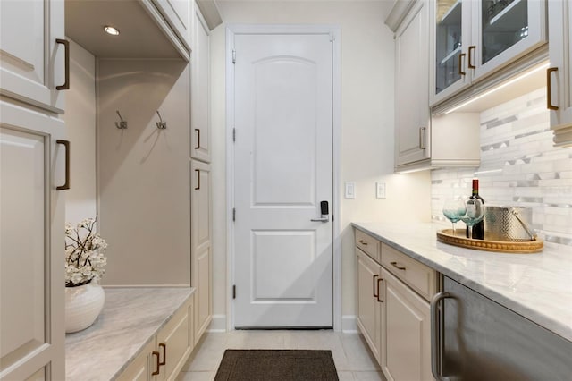 mudroom with light tile patterned floors and baseboards