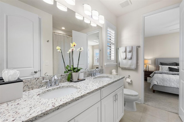 bathroom featuring tile patterned floors, toilet, visible vents, and a sink