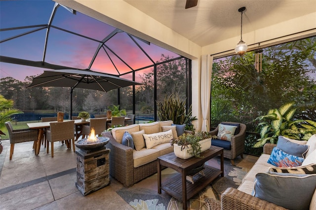 view of patio with outdoor lounge area, glass enclosure, and outdoor dining area