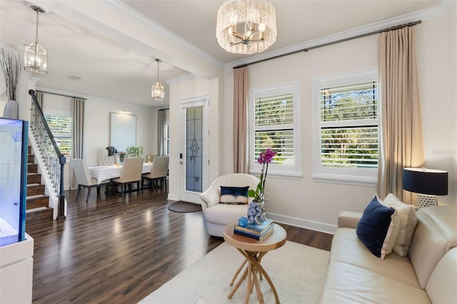 living room featuring baseboards, stairway, ornamental molding, wood finished floors, and a notable chandelier