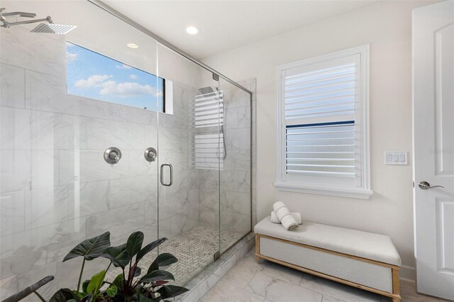 full bath featuring marble finish floor and a stall shower