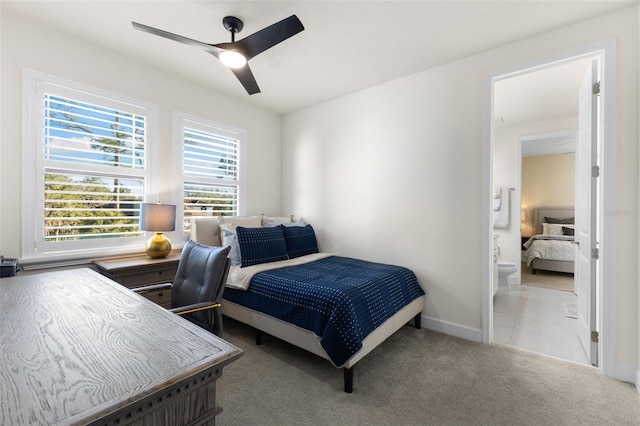 carpeted bedroom with ceiling fan and baseboards