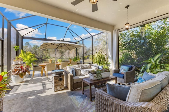 view of patio featuring a lanai, outdoor lounge area, outdoor dining area, and ceiling fan