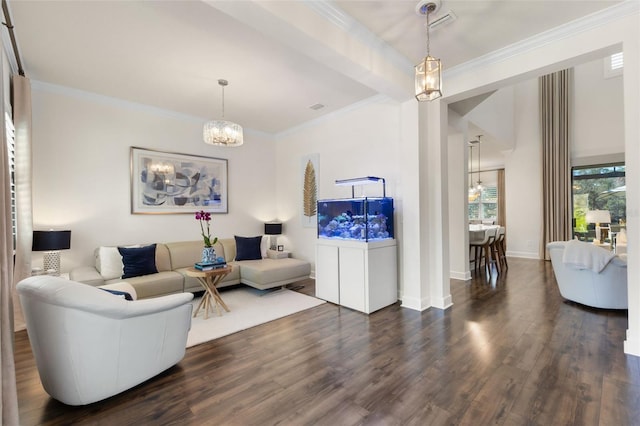 living area with visible vents, crown molding, baseboards, a chandelier, and dark wood finished floors