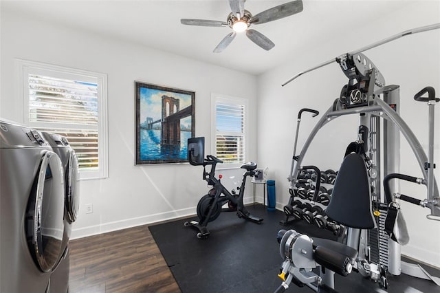 exercise room with ceiling fan, baseboards, wood finished floors, and washing machine and clothes dryer