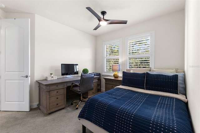 bedroom featuring light colored carpet and a ceiling fan