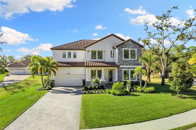 view of front of home featuring stone siding, stucco siding, a front yard, and a garage