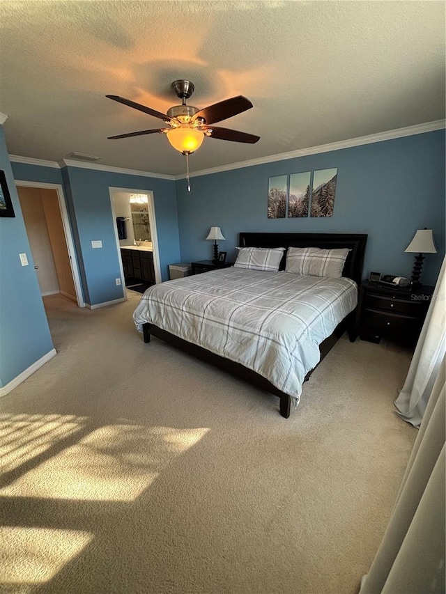 carpeted bedroom with a textured ceiling, ceiling fan, crown molding, and ensuite bathroom