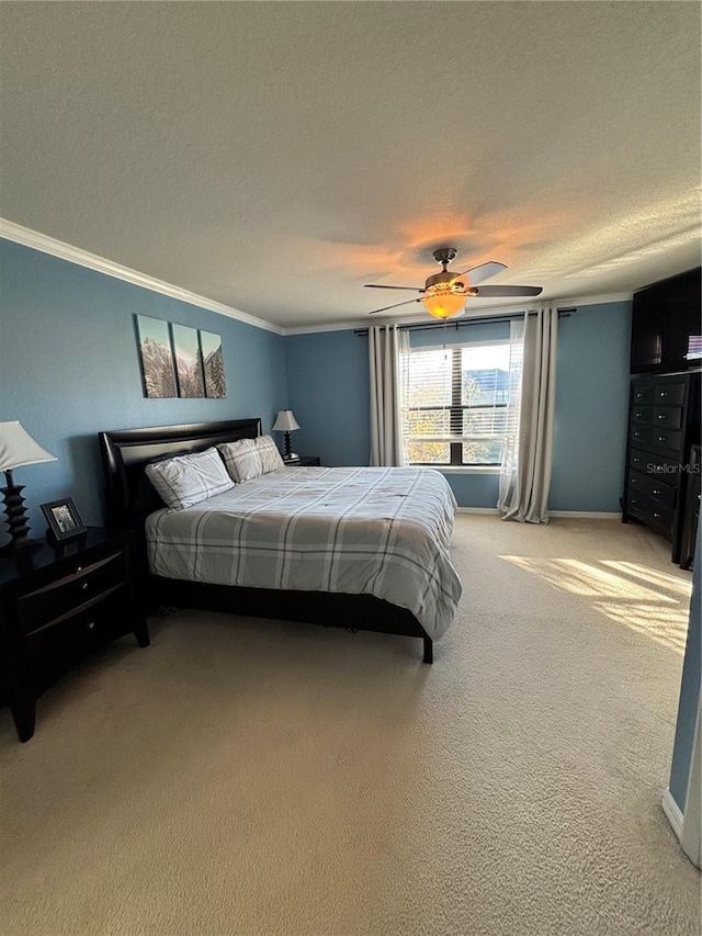 bedroom with ceiling fan, carpet, a textured ceiling, and ornamental molding