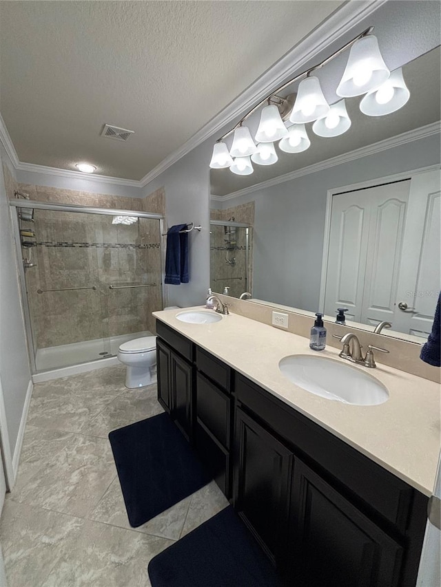 bathroom with crown molding, a textured ceiling, toilet, a shower with door, and vanity