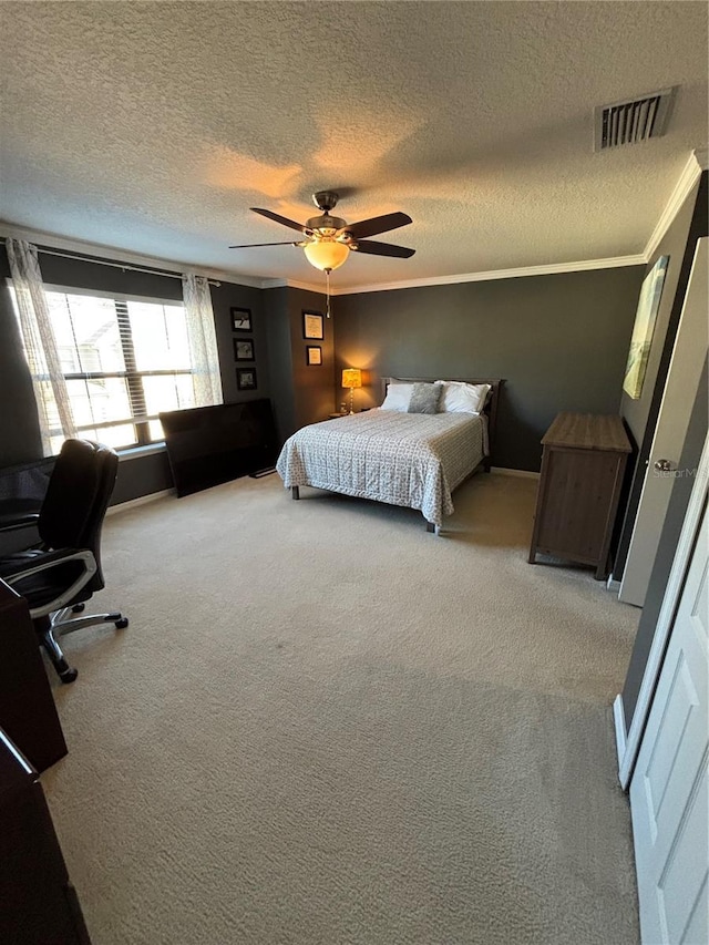 carpeted bedroom with ceiling fan, a textured ceiling, and ornamental molding