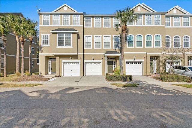 townhome / multi-family property featuring a garage