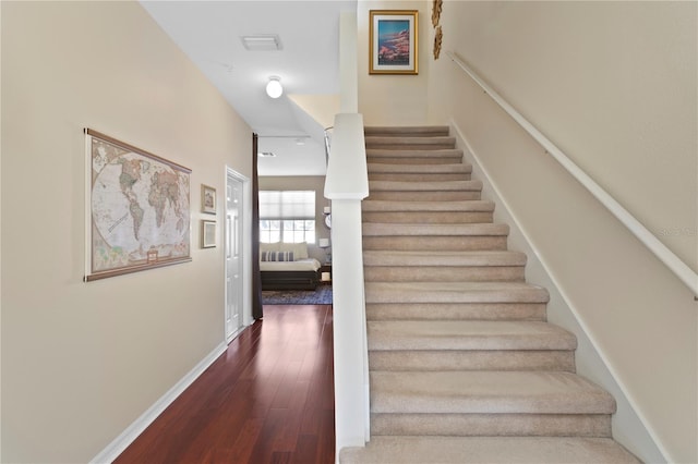 staircase with hardwood / wood-style floors