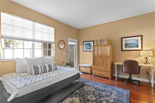 bedroom with dark hardwood / wood-style floors