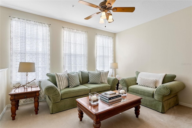 living room featuring light colored carpet and ceiling fan