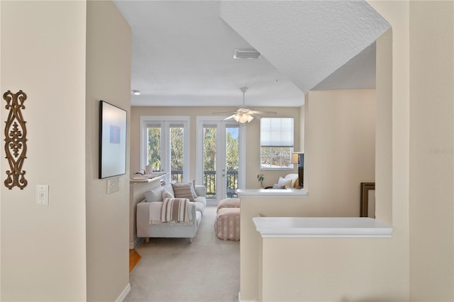 bedroom featuring ceiling fan, french doors, carpet floors, and a textured ceiling