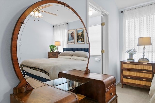 bedroom with vaulted ceiling, ceiling fan, and light carpet