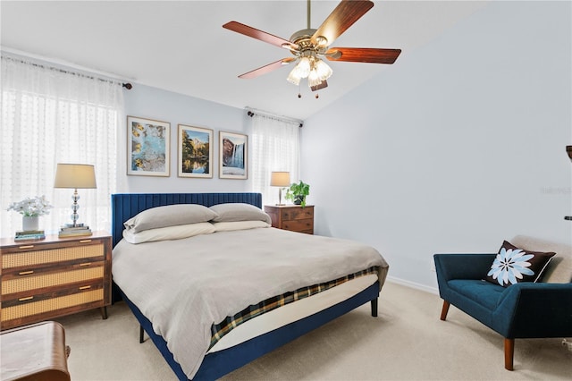 bedroom featuring lofted ceiling, multiple windows, ceiling fan, and light colored carpet