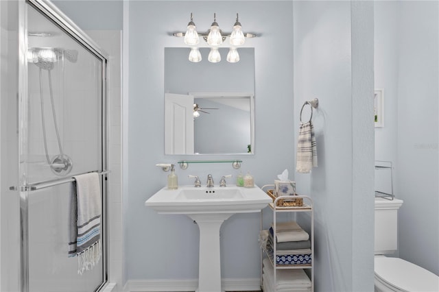 bathroom featuring ceiling fan, walk in shower, and toilet