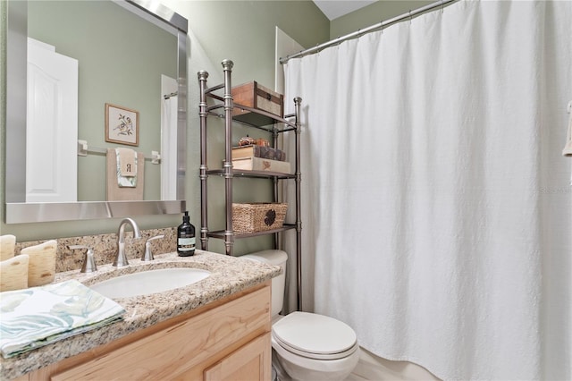 bathroom featuring toilet and vanity