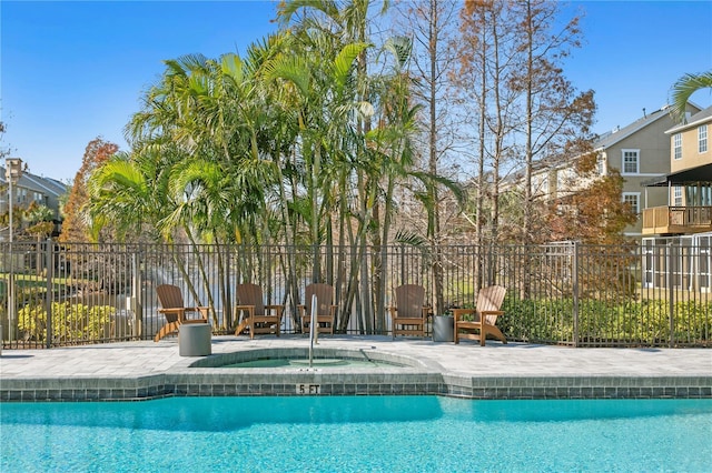 view of swimming pool featuring an in ground hot tub