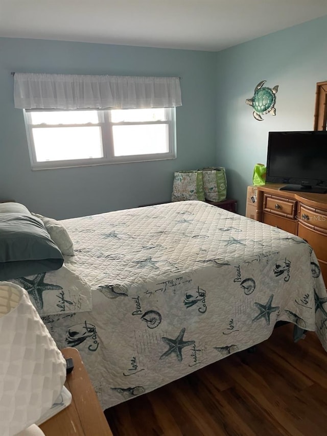 bedroom featuring hardwood / wood-style flooring and multiple windows