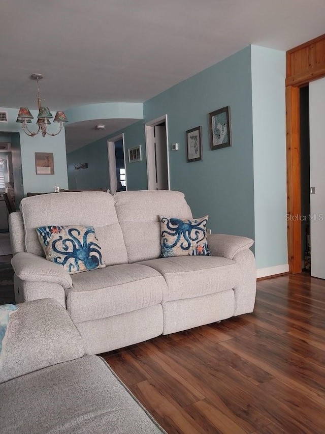 living room with hardwood / wood-style floors and an inviting chandelier