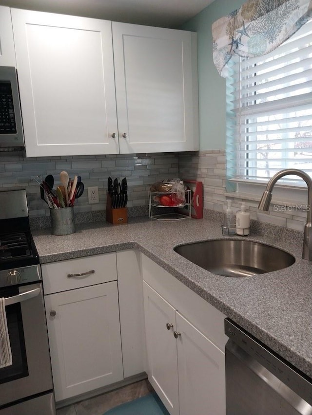 kitchen featuring sink, stainless steel appliances, and white cabinets