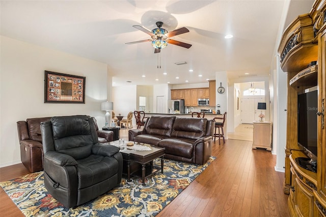 living room featuring hardwood / wood-style flooring and ceiling fan