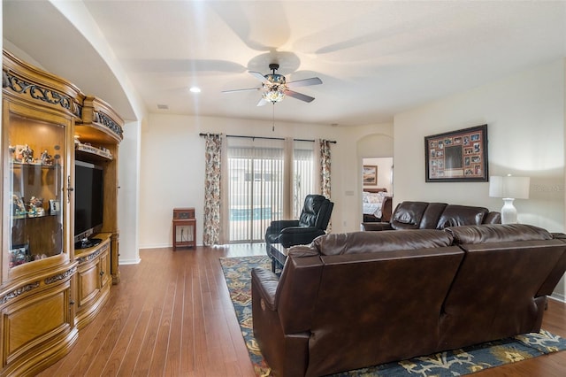 living room featuring dark hardwood / wood-style floors and ceiling fan