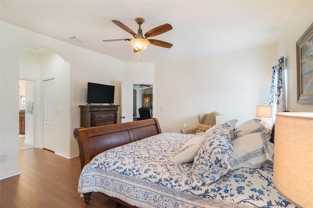 bedroom with dark hardwood / wood-style floors and ceiling fan