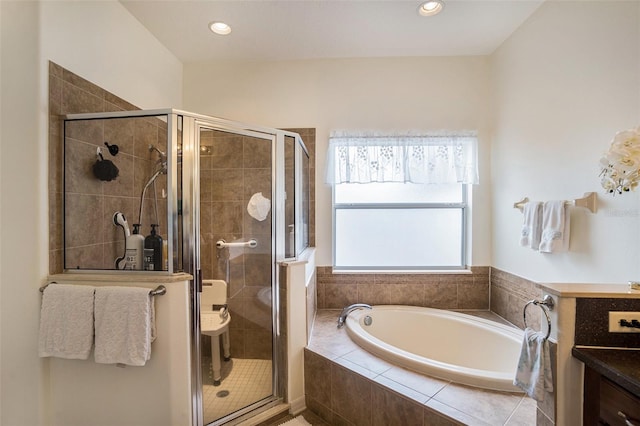 bathroom featuring shower with separate bathtub and vanity