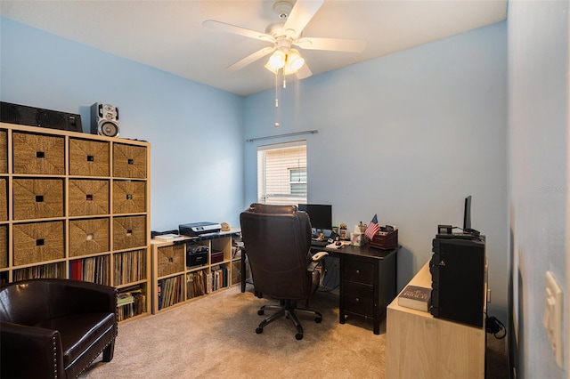 carpeted home office featuring ceiling fan