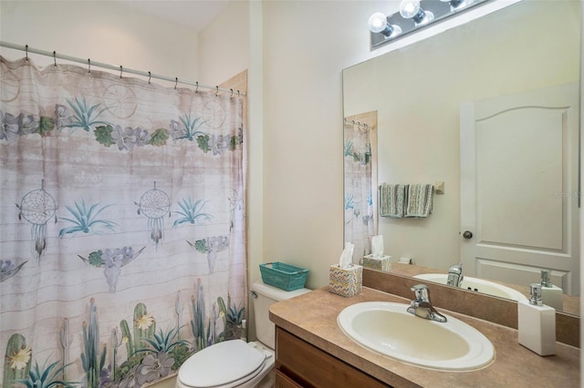 bathroom featuring vanity, a shower with shower curtain, and toilet