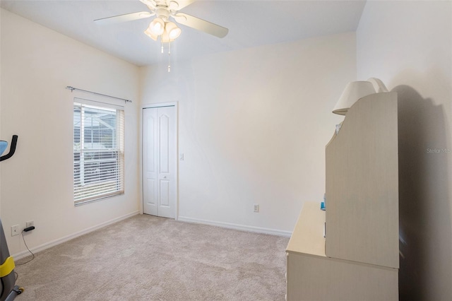 empty room featuring light colored carpet and ceiling fan