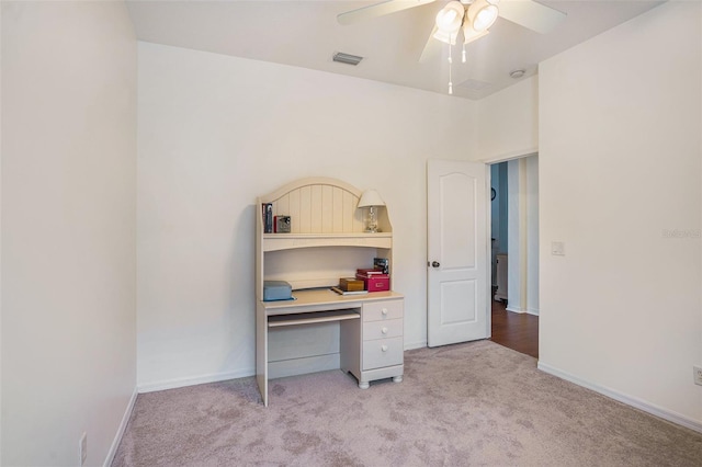 carpeted home office featuring ceiling fan