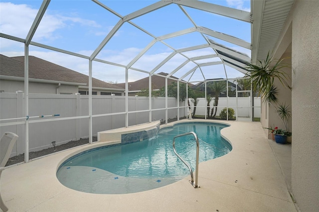 view of swimming pool featuring a patio and glass enclosure